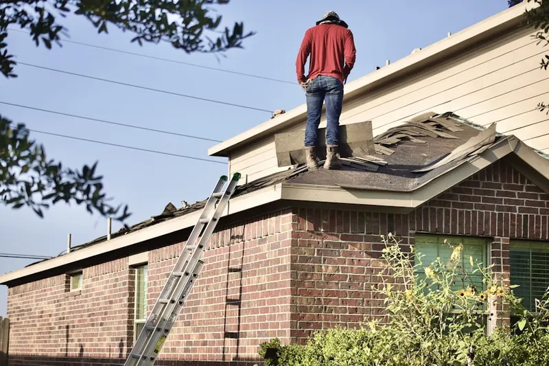 Professional roofer working on a residential roof in North Port Norris
